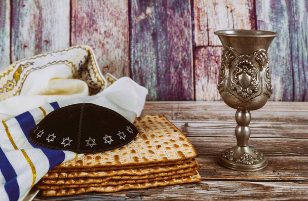 A Jewish Matzah bread and wine with kipah and tallit Passover holiday concept - Photo, Image