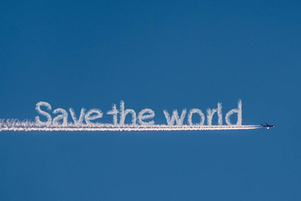 Save the world cloud text and airplane in blue sky  - Photo, Image