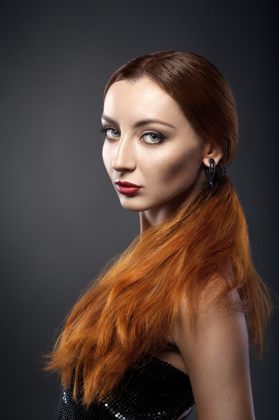 beautiful young redhead woman isolated on dark background - Фото, зображення