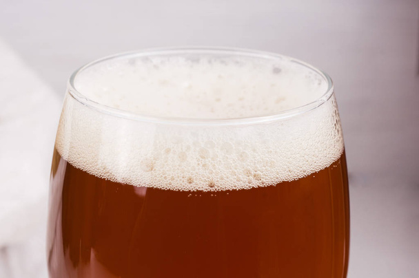beer foam in glass of home made craft beer and bag of light malt - Photo, Image