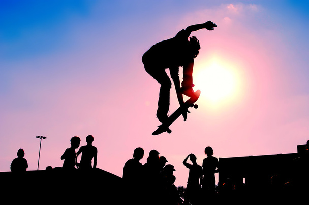 Jumping skateboarder silhouette - 写真・画像