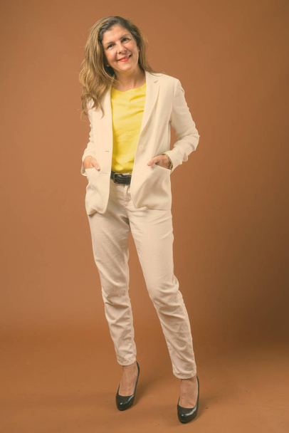 Portrait of mature beautiful businesswoman wearing pantsuit - Foto, afbeelding