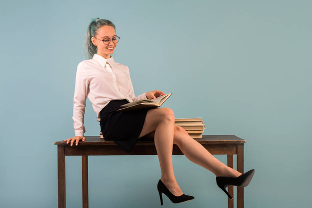 beautiful young woman sits on a table - Valokuva, kuva