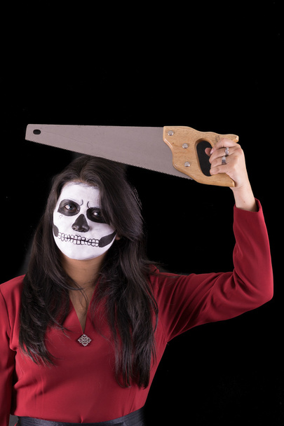 Woman in Halloween costume with a saw - Foto, afbeelding