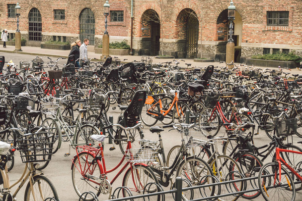 Copenhagen, Denmark. February 20, 2019. lots of Bicycles on bicycle parking in front of Danish Parliament building. Christiansborg palace. concept of healthy lifestyle and reducing carbon emissions - Fotoğraf, Görsel