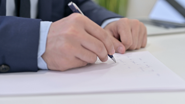 Businessman Writing on Paper at Work - Video