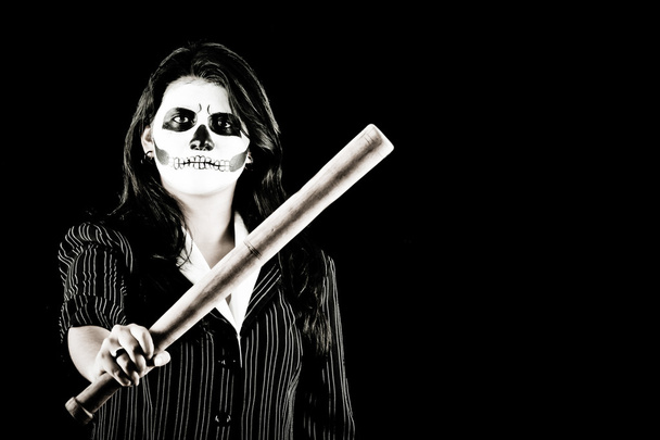 Woman in Halloween costume with a baseball bat - Foto, afbeelding