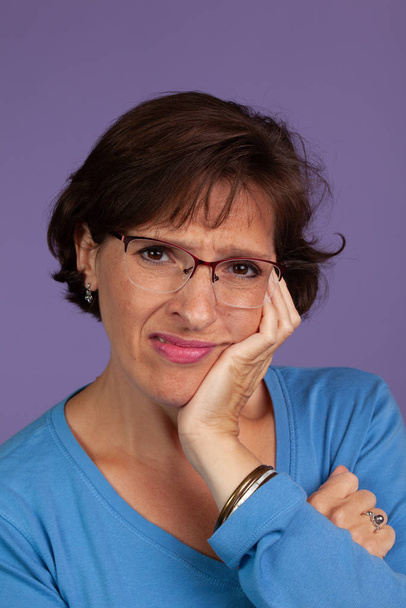 Woman adjusting her glasses - Foto, afbeelding