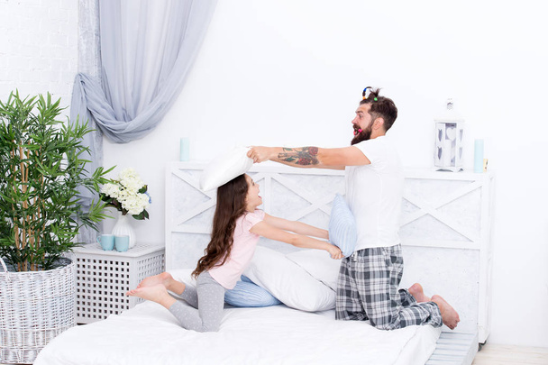 Together we make family. Happy family. Family of father and daughter have fun in bedroom. Father and little child play pillow fight. Family games - Fotografie, Obrázek