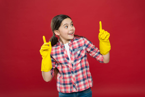 Inspiring changes. Spring cleaning. House cleaning service. Cleaning supplies. Small girl rubber gloves for cleaning red background. Appreciate cleanliness. Clean house. Housekeeping duties - Фото, зображення