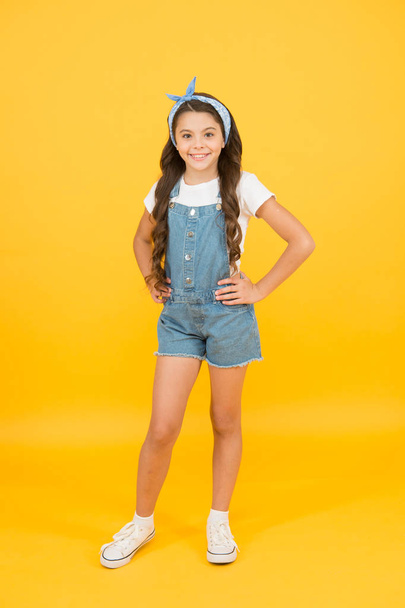 Hair care. Active lifestyle. Energy inside. Vacation time. Fashion trend. Little fashionista yellow background. Cute kid fashion girl. Summer fashion concept. Girl long curly hair tied headscarf - 写真・画像