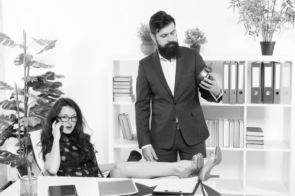 Time is short. Start now. Bearded man hold clock while sexy woman talking on phone. Work time or working hours. Time management. Startup company. Time for new start - Φωτογραφία, εικόνα