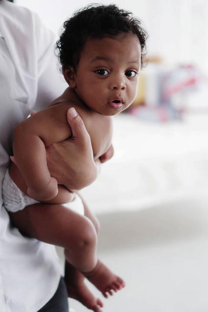 portrait of african american baby girl on hand of mother - Фото, зображення