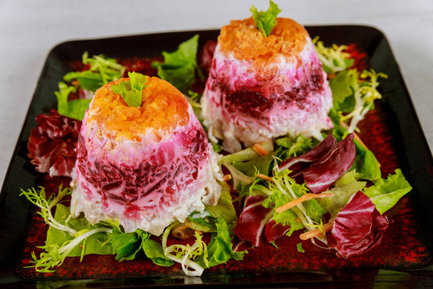 Beetroot salad with herring and vegetable layered with mayonnaise. - Fotoğraf, Görsel