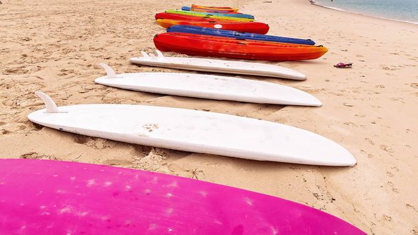 Surfboards and Kayaks on a Sandy Beach For Tourrists to Hire
 - Фото, изображение