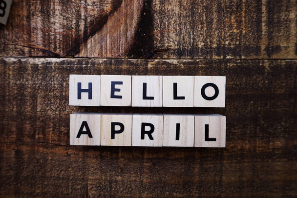 Hello April alphabet letter top view on wooden background - Фото, изображение