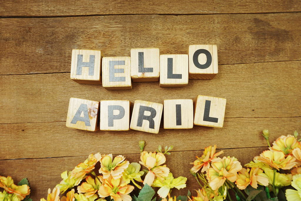 Hello April alphabet letters with space copy and  flower on wooden background - Photo, Image