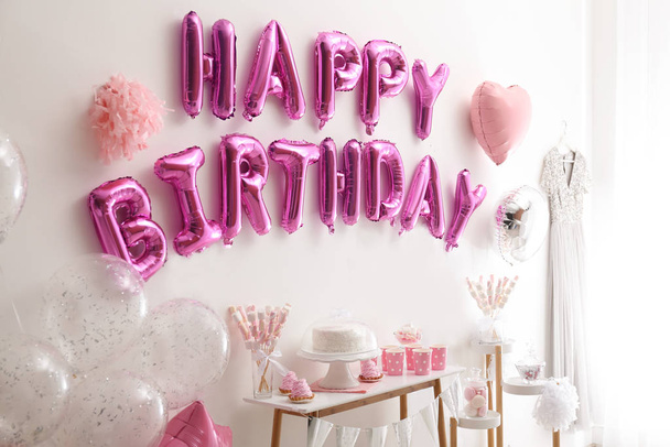 Phrase HAPPY BIRTHDAY made of pink balloon letters in decorated room - Fotografie, Obrázek