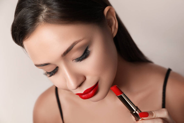 Beautiful woman with red lipstick on light background - Fotografie, Obrázek
