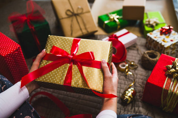 Gift wrapping, woman packing holiday gifts at home - Valokuva, kuva