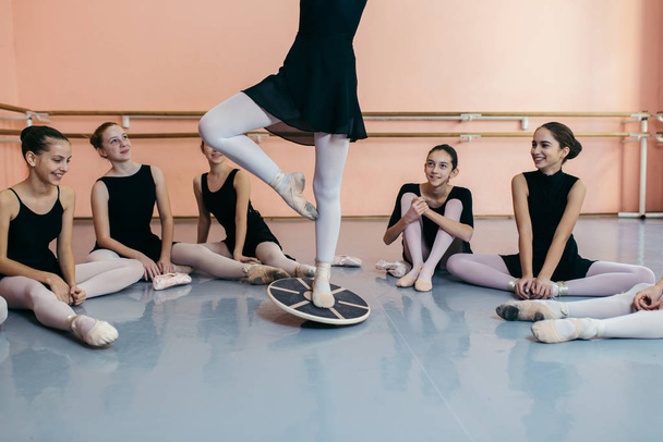 Choreographed dance by a group of beautiful young ballerinas practicing during class at a classical ballet school. - Photo, Image