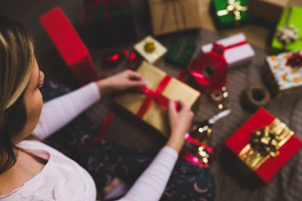 Gift wrapping, woman packing holiday gifts at home - Valokuva, kuva