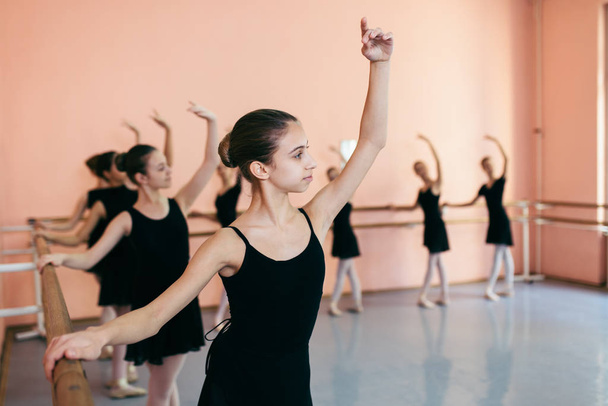 The group of beautiful teenage girls practicing ballet dance. - Photo, Image