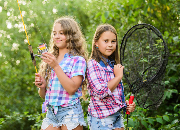 Fishing skills. Summer hobby. Happy smiling children with net and rod. Happy childhood. Adorable girls nature background. Teamwork. Camping activities. Fly fishing. Kids spend time together fishing - Foto, Imagem