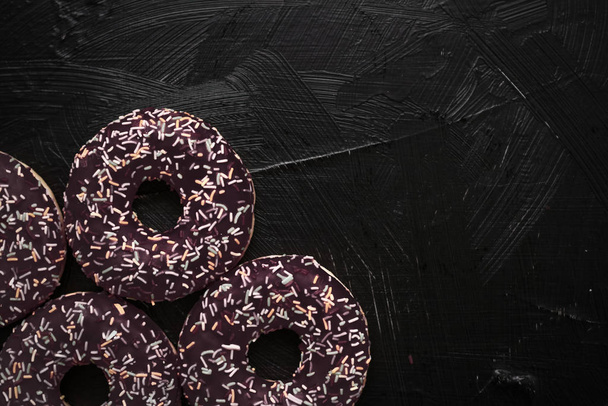 Frosted sprinkled donuts, sweet pastry dessert on rustic wooden  - Photo, image