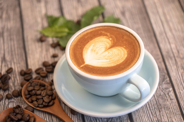 koffiekopje met latte art - Foto, afbeelding
