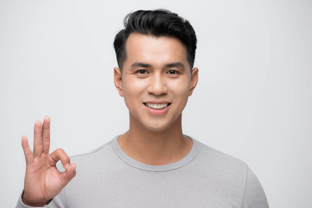 portrait of an asian man doing the okay gesture - Photo, Image