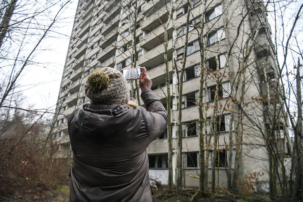 Former residents of Pripyat in ghost town Prypiat in Chornobyl exclusion zone. Ukraine, December 2019 - Фото, изображение