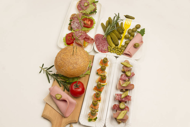 Assortment of canapes with salmon, bacon, cheese, pickles on  white - Foto, Imagen