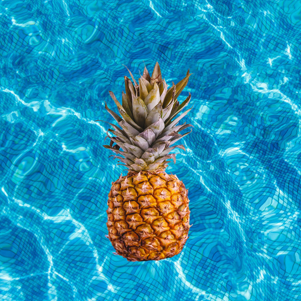Juicy ripe pineapple fruit swims with a wine pool. Top view with copy space. - Fotoğraf, Görsel