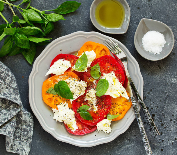 salad of tomato, mozzarella and basil. Italian food. - Фото, изображение