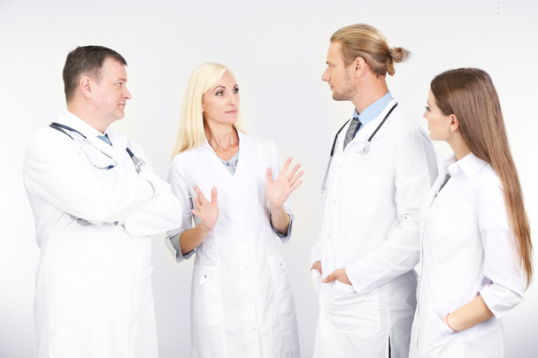 Medical workers on grey background - Foto, Imagen