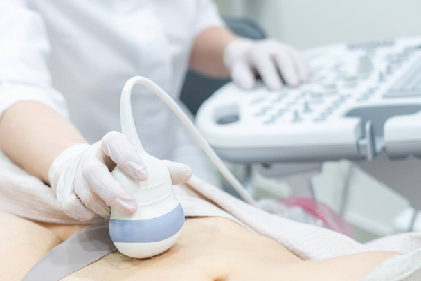 Gynecologist doing ultrasound scan in modern clinic - Fotografie, Obrázek