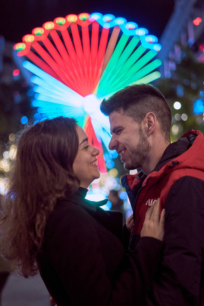 Young couple enjoying Christmas Lights - 写真・画像