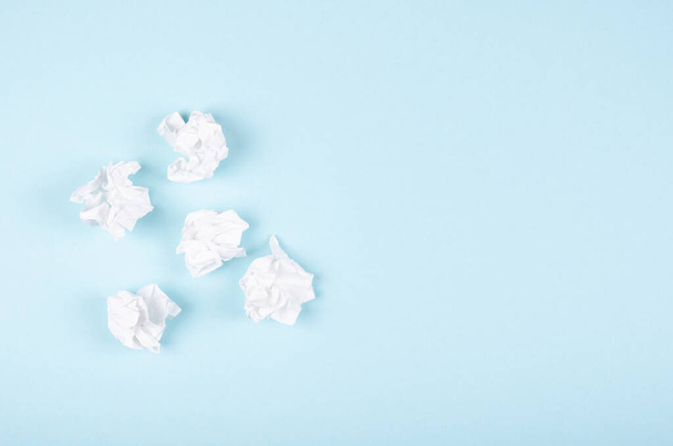 Crumpled paper composition on blue background. Flat lay. - Foto, afbeelding