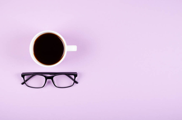 Coffee cup composition on purple background. Flat lay. - 写真・画像