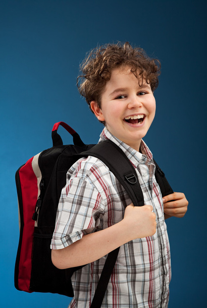 Student with backpack reading book - Foto, Imagen