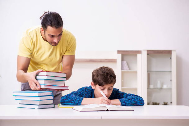 Father helping his son to prepare for school - Photo, image