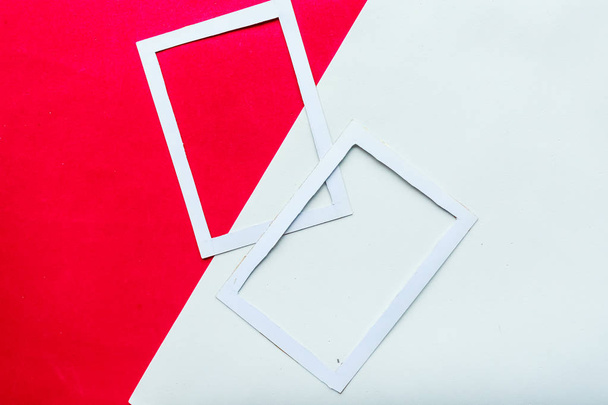Two white mockup photo frames on geometric red and white background. Copy space for the text - Photo, Image