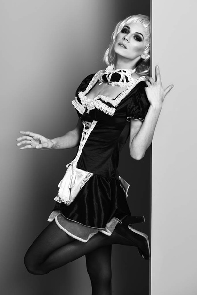 waitress or maid sexy girl on blue green studio background - Foto, afbeelding