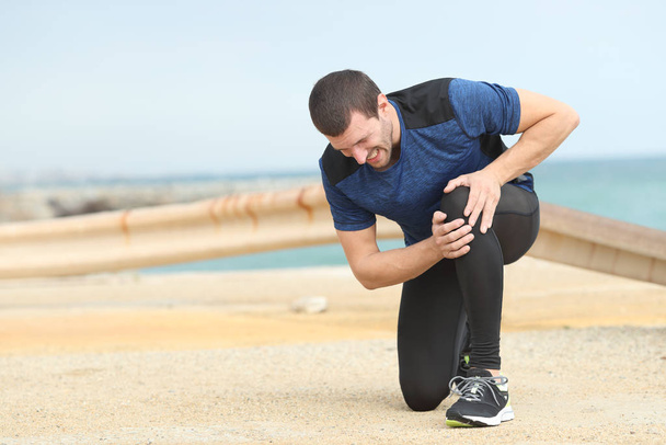Runner complaining suffering knee ache after sport - Фото, изображение
