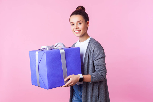 Holiday present and bonuses. Portrait of cheerful teenage brunet - Photo, Image