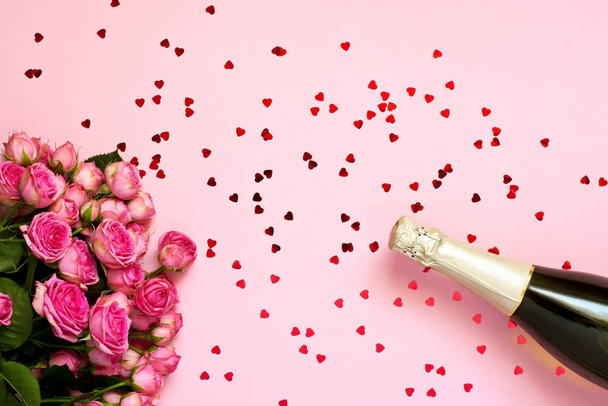 Champagne  bottle and roses bouquet , holiday background - Photo, image