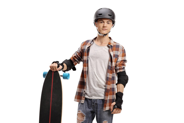 Guy with a longboard and protective equipment  - Foto, afbeelding