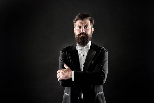 Make statement. Confident man black background. Bearded man keep arms crossed with confidence. Confident look of fashion hipster. Classy tuxedo makes him feel confident. Confident at every occasion - Photo, image