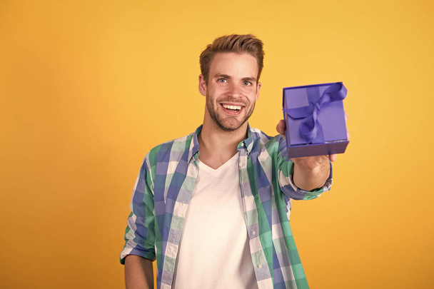 This is for you. Man with beard and happy face celebrate valentines day. Valentines day gift. Romantic gift. Hipster smiling hold gift box. Love and romantic feelings concept. Surprise concept - Φωτογραφία, εικόνα